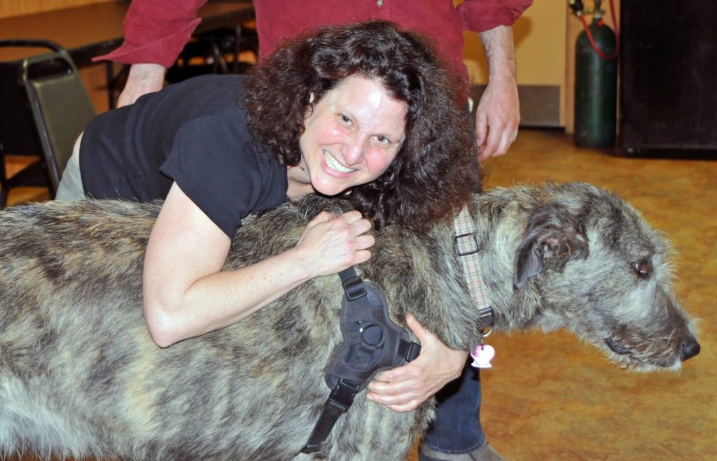 Joana hugging a irish wolfhound during therapy dog class